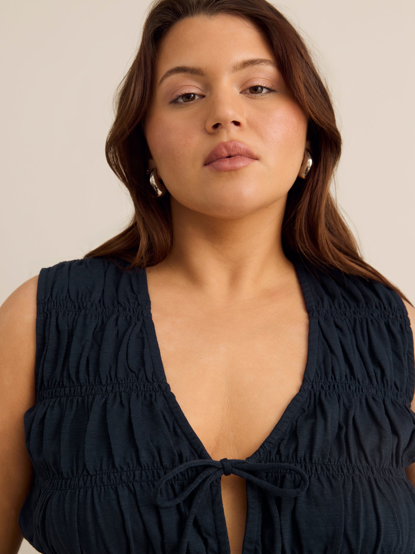 Flared Sleeveless V-Neck Tie-Front Smocked Blouse - Addition Elle