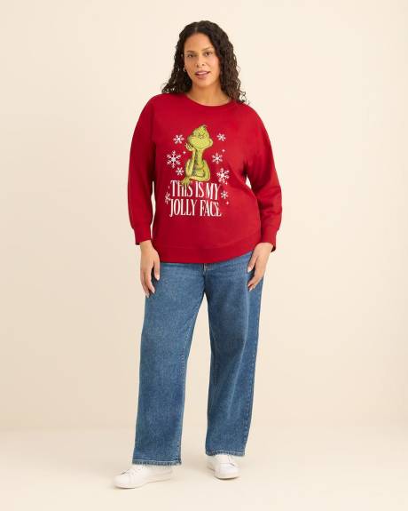 Pull rouge à col rond avec imprimé du Grinch