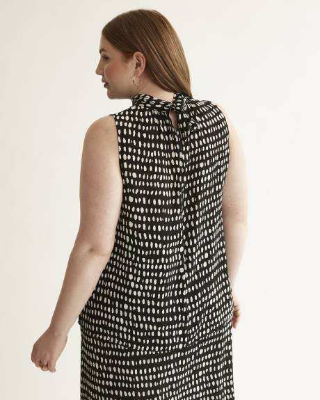 Blouse sans manches à col montant, motifs à pois allongés