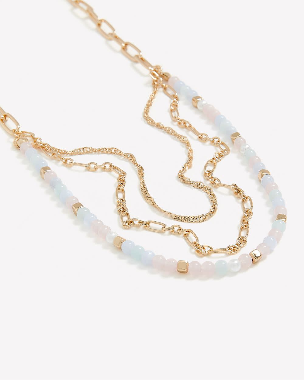 Collier à chaînes multiples dorées avec billes blanches