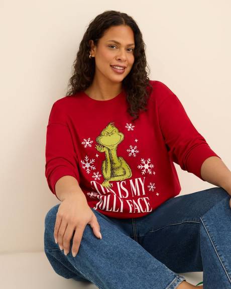 Pull rouge à col rond avec imprimé du Grinch
