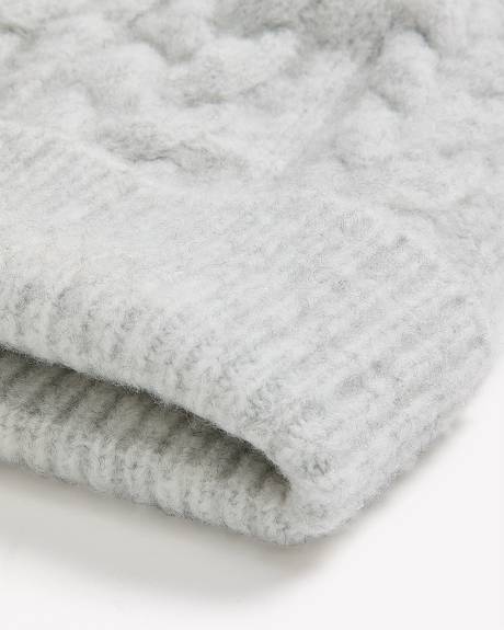 Bonnet à revers en laine à mailles torsadées avec pompon Bonnet à revers en laine à mailles torsadées avec pompon