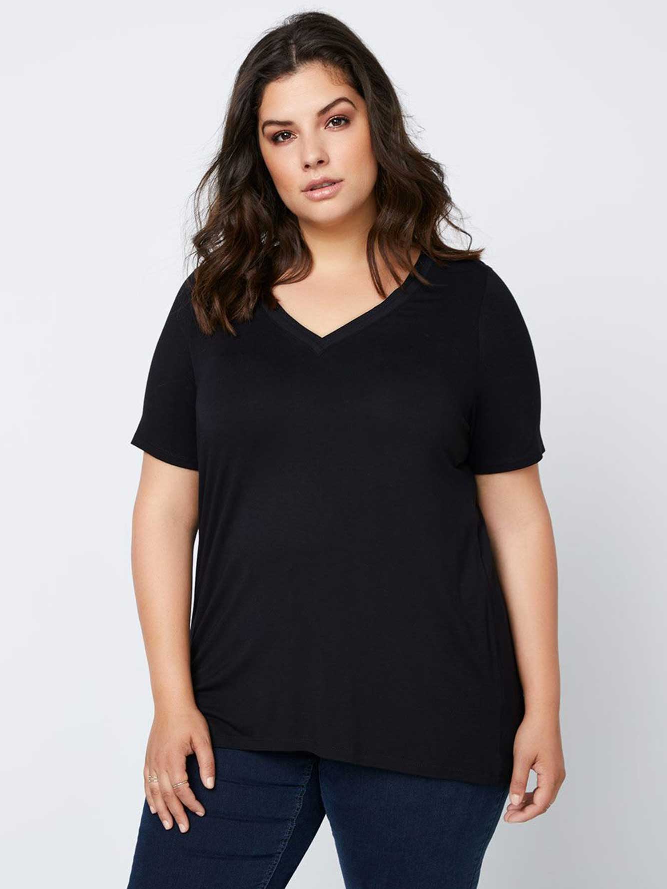Cute and basic - the ultimate comfy and stylish combo! This plus-size from In Every Story features a double band v-neckline in front, short elbow sleeves, high and low hem, and offers a slightly fitted cut that works to flatter and outline your curvy silhouette. Whats more? Its made with ultra-soft and stretchy fabric. Now all you need is your fave jean bottom to pair! Length: 28 1/2" at front, 29" at back