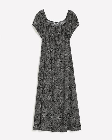 Robe longue noire à pois avec encolure carrée et manches bouffantes, tissu responsable