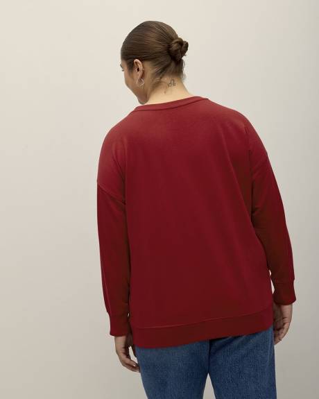 Pull rouge à col rond avec imprimé du Grinch
