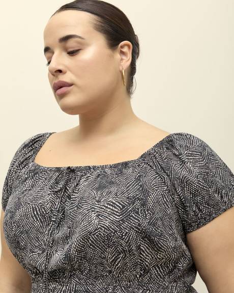 Robe longue noire à pois avec encolure carrée et manches bouffantes, tissu responsable