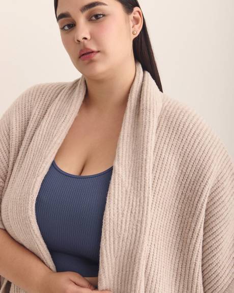 Cape en tricot côtelé épais avec poches